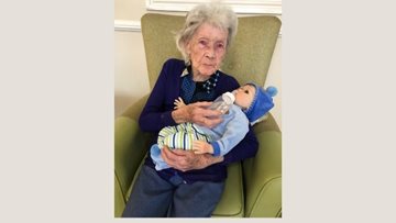 Resident spending time with baby at Rochdale care home
